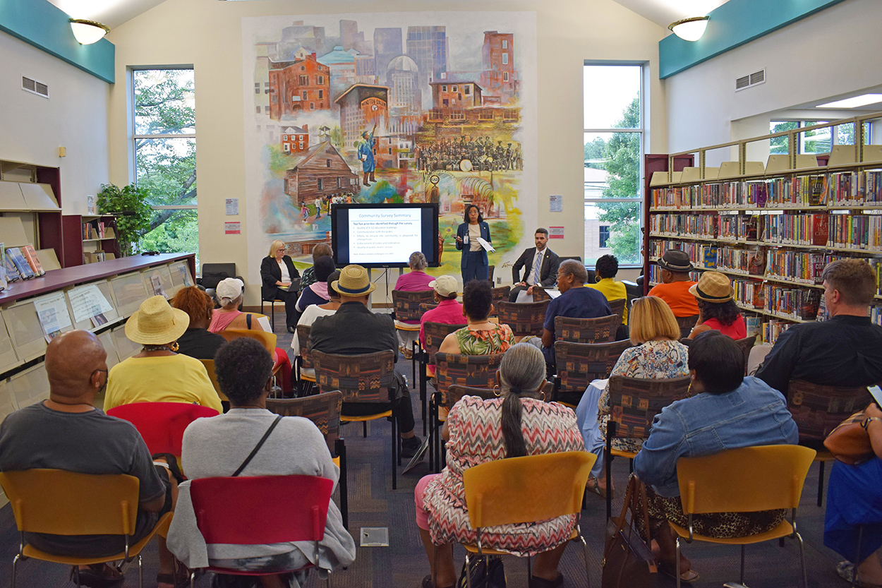 County Manager Shontell Robinson speaking to an audience inside a library